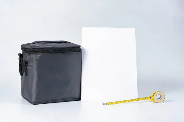 Blank artwork placement sheet next to cooler bag